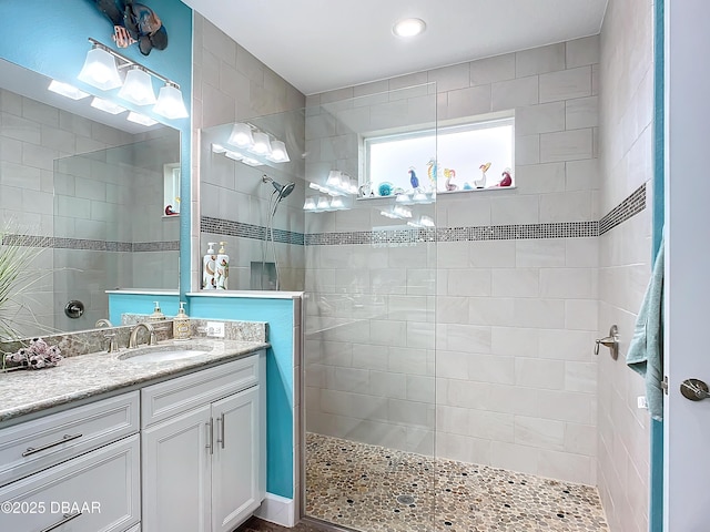 full bath featuring walk in shower and vanity