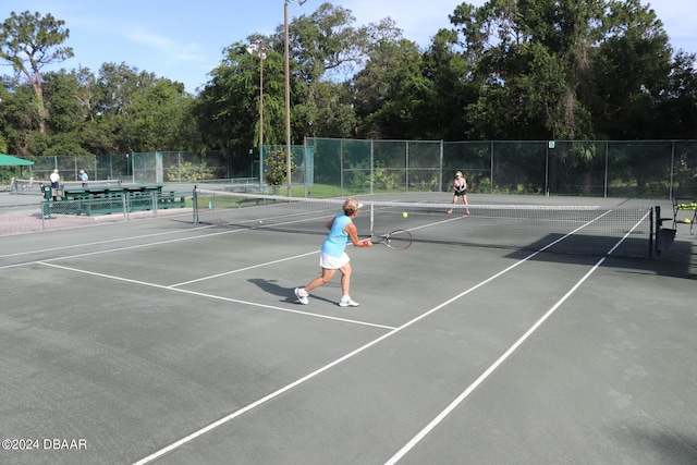 2051 Cornell Pl Unit 26, Port Orange, FL 32128 - view of tennis court featuring community basketball court and view of wooded area