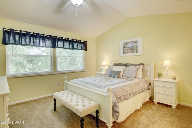 bedroom with lofted ceiling, light colored carpet, and ceiling fan