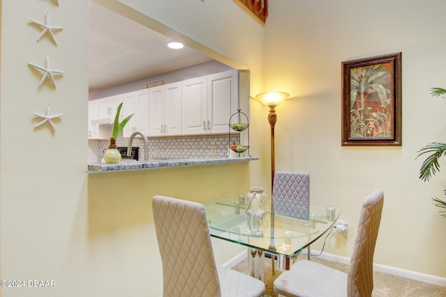 dining area featuring light colored carpet