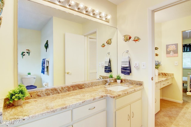 bathroom featuring toilet and vanity