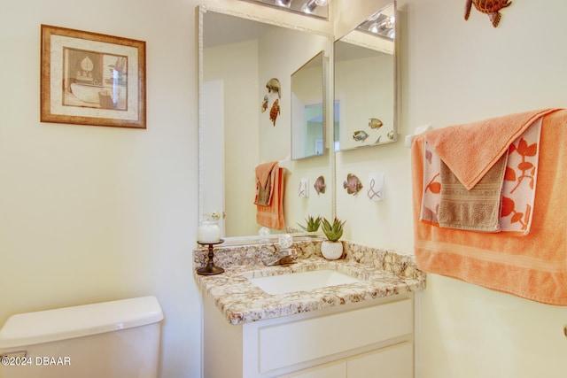 bathroom with toilet and vanity