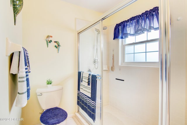 bathroom with toilet, a shower with shower door, and tile patterned floors