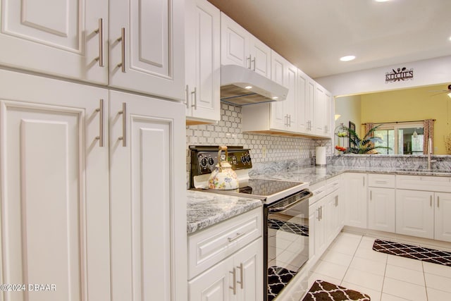 2051 Cornell Pl Unit 26, Port Orange, FL 32128 - kitchen featuring under cabinet range hood, electric range oven, tasteful backsplash, white cabinetry, and light tile patterned floors