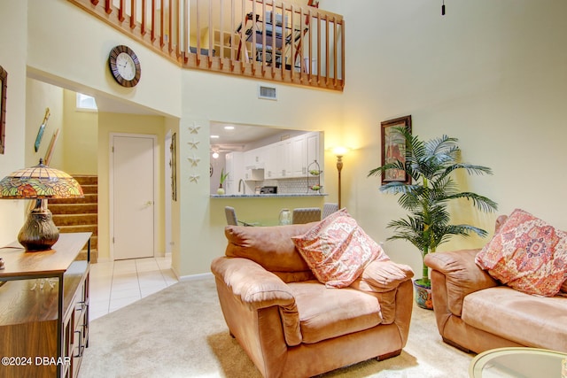 carpeted living room with a high ceiling