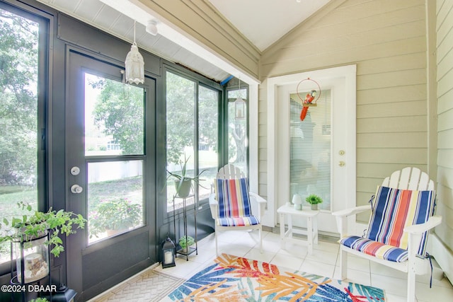 2051 Cornell Pl Unit 26, Port Orange, FL 32128 - sunroom / solarium featuring vaulted ceiling, tile patterned flooring, and wooden walls