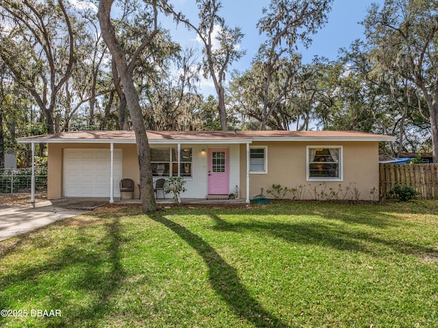 ranch-style house featuring a garage and a front yard