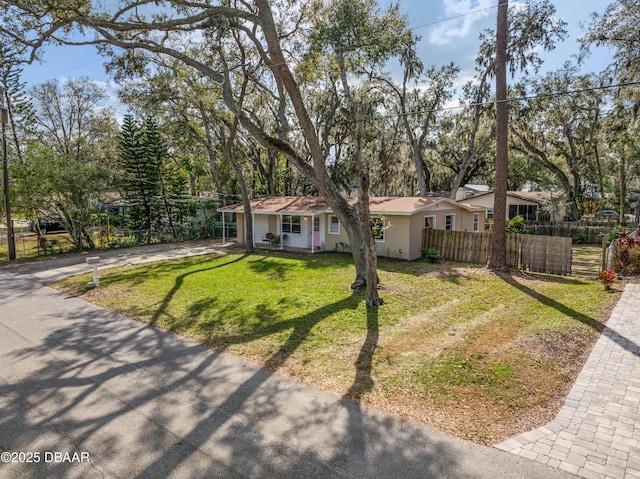 ranch-style home with a front lawn