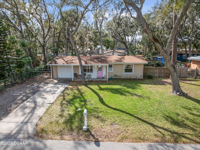 single story home featuring a garage and a front lawn