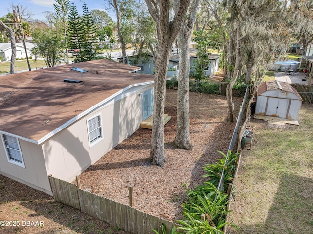 view of side of home featuring a shed