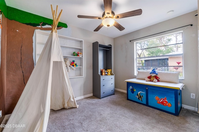 rec room with ceiling fan and light carpet