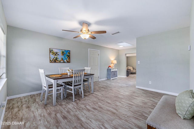 dining space with ceiling fan and hardwood / wood-style floors