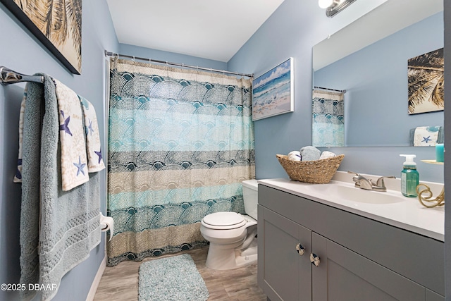 bathroom featuring vanity, hardwood / wood-style floors, curtained shower, and toilet