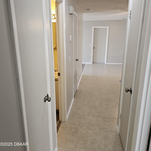 hall featuring light tile patterned flooring