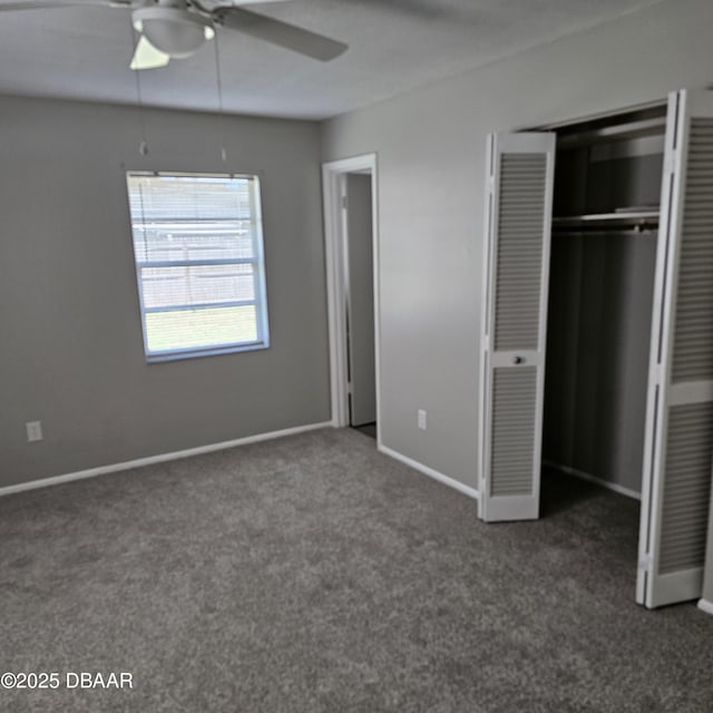 unfurnished bedroom with a closet, ceiling fan, and dark colored carpet