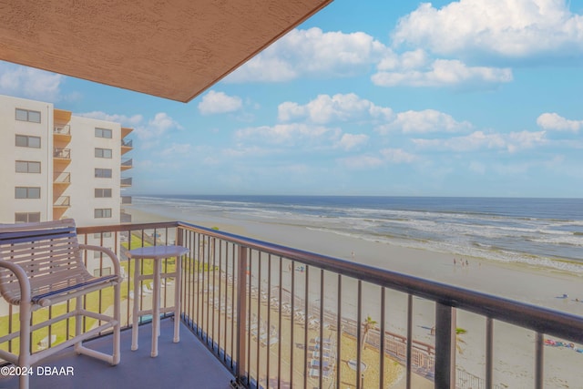 balcony with a view of the beach and a water view