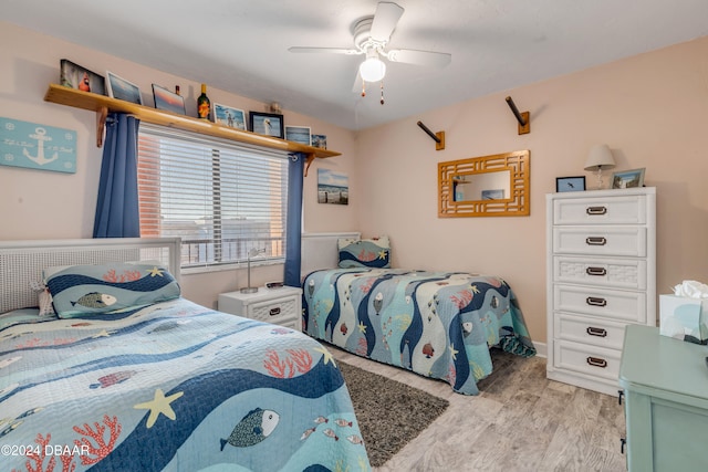 bedroom with light hardwood / wood-style floors and ceiling fan