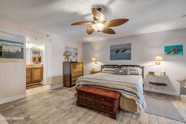 bedroom with light hardwood / wood-style floors, ceiling fan, and connected bathroom