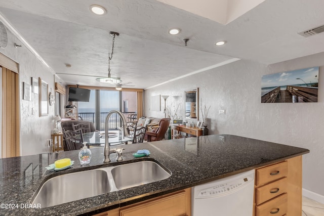 kitchen with dishwasher, a textured ceiling, sink, crown molding, and decorative light fixtures