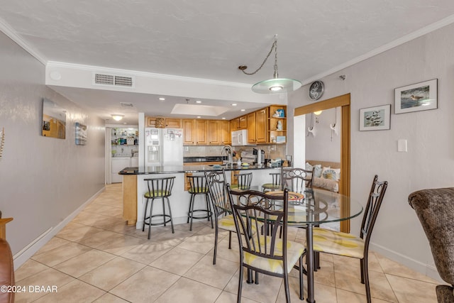4141 S Atlantic Ave Unit 502, New Smyrna Beach, FL 32169 - dining area featuring crown molding, light tile patterned flooring, and baseboards