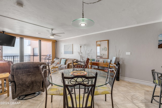 dining space with light tile patterned floors, ceiling fan, and crown molding