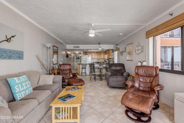 tiled living room with ceiling fan and crown molding