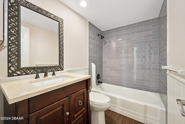 2800 N Atlantic Ave Unit 101, Daytona Beach, FL 32118 - full bath featuring shower / tub combination, toilet, vanity, wood finished floors, and a wainscoted wall