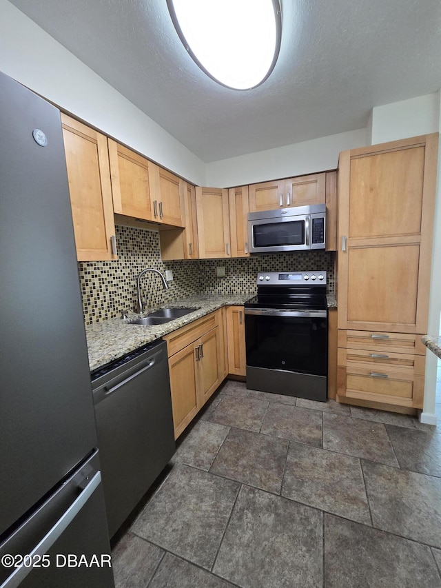 2800 N Atlantic Ave Unit 101, Daytona Beach, FL 32118 - kitchen with appliances with stainless steel finishes, a sink, tasteful backsplash, and light stone countertops