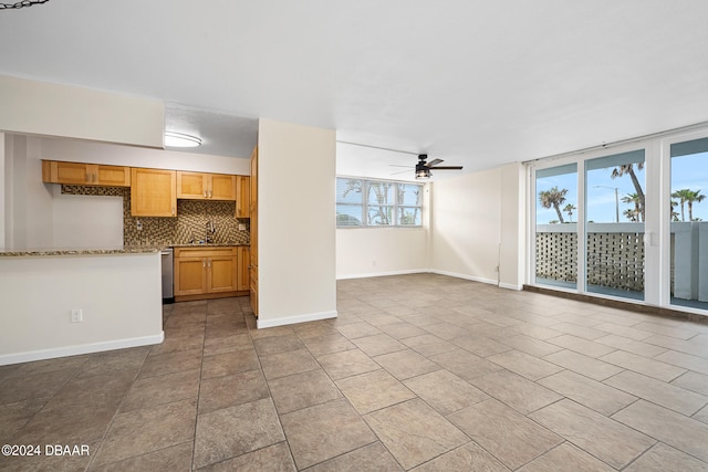 unfurnished living room featuring light tile patterned floors and ceiling fan