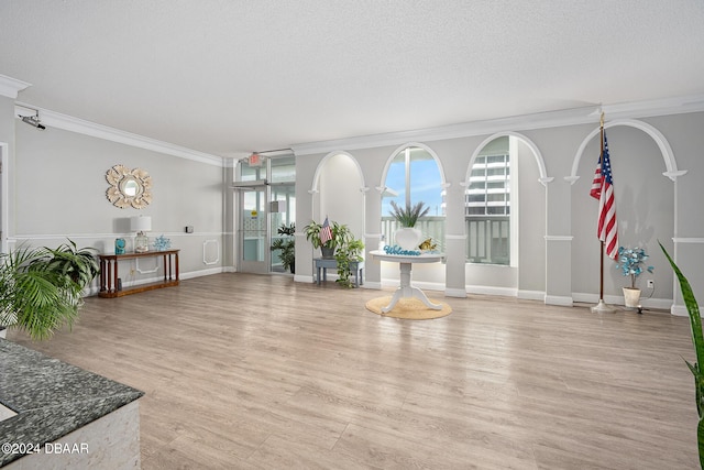 2800 N Atlantic Ave Unit 101, Daytona Beach, FL 32118 - foyer with crown molding, plenty of natural light, light wood finished floors, and baseboards