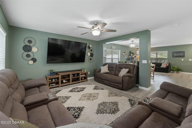 living room with ceiling fan and light hardwood / wood-style floors