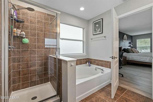 bathroom featuring tile patterned flooring and independent shower and bath