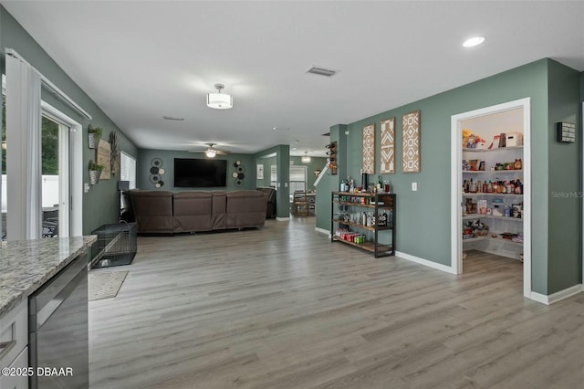 living room featuring light hardwood / wood-style floors and ceiling fan