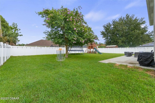 view of yard featuring a playground, a trampoline, and a patio