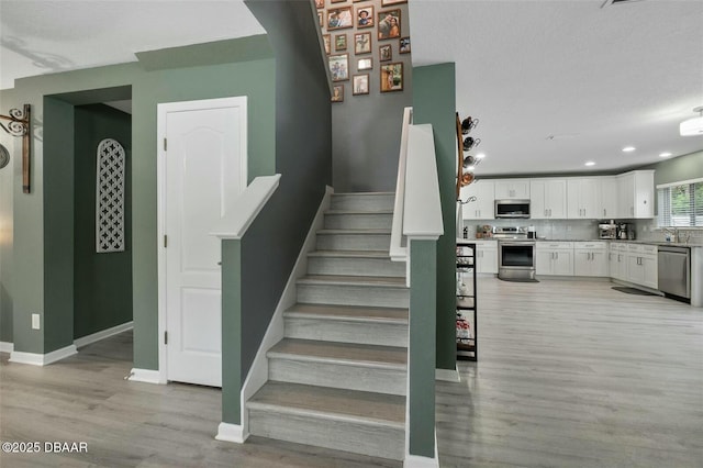 stairway featuring hardwood / wood-style flooring