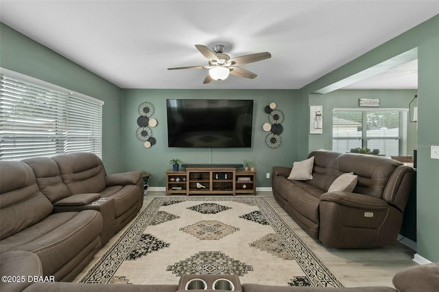 living room with ceiling fan and light hardwood / wood-style floors