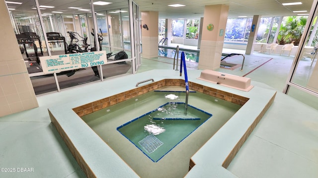 view of pool with an indoor hot tub