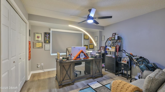 office area with ceiling fan, hardwood / wood-style floors, and a textured ceiling