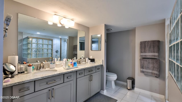 bathroom with tile patterned flooring, vanity, an enclosed shower, and toilet