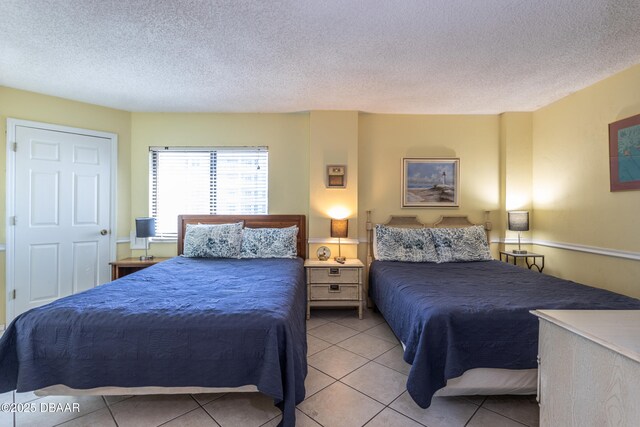 tiled bedroom with a textured ceiling