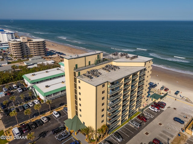 drone / aerial view featuring a water view and a view of the beach