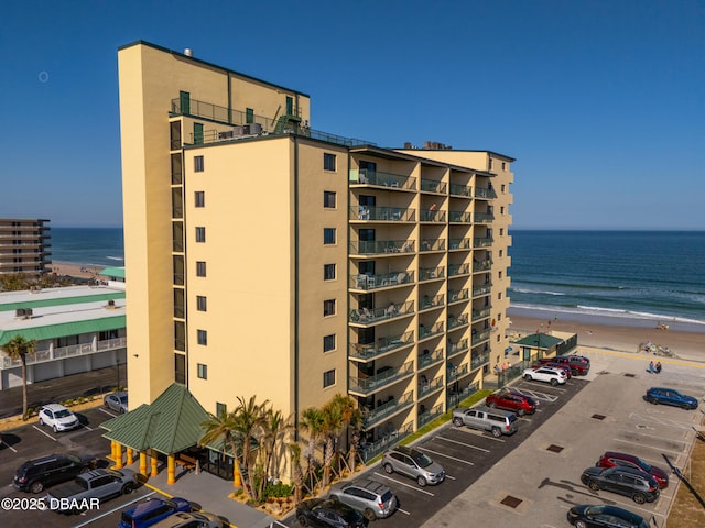 view of property featuring a water view and a view of the beach