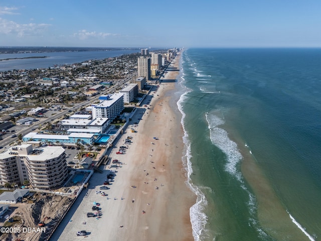 birds eye view of property with a water view and a view of the beach