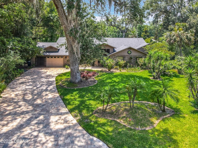 4073 N Chinook Ln, Ormond Beach, FL 32174 - view of front facade featuring a front lawn, driveway, and an attached garage