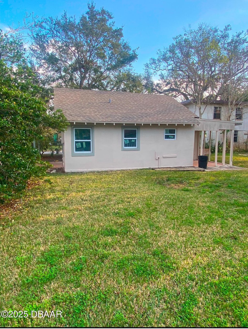 back of house with a yard