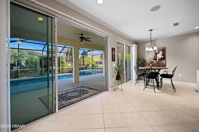 dining room featuring ceiling fan, ornamental molding, and light tile patterned floors