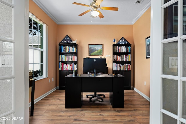 office space featuring ceiling fan, ornamental molding, and hardwood / wood-style floors