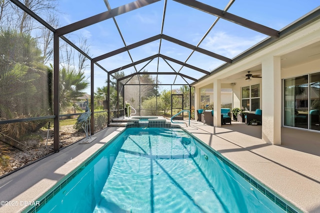 view of pool featuring a patio area, a lanai, an in ground hot tub, ceiling fan, and an outdoor hangout area