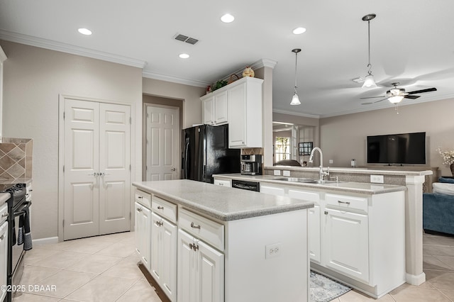 kitchen featuring white cabinets, sink, a kitchen island, and black appliances