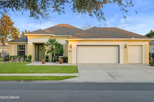 view of front of property with a garage and a front lawn